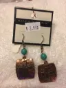 Burnished metal deco bible letter cross earrings. Color copper/turquoise